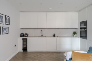 Kitchen features an oven, microwave, and sleek countertop.