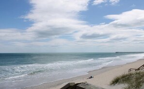 A beach with a wooden walkway and a pier in the distance. - The Treasure Chest - 3 BR/2 BA Upper Part of Duplex in the Heart of Surf City (Surf City)