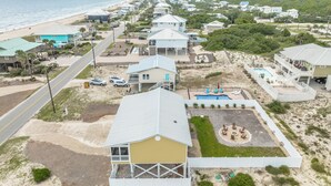 A coastal residential area with houses, a beach, and a swimming pool. - Welcome to the “Pot O’ Gold” at the end of the rainbow! (St. George Island)