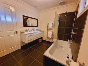 Combined shower/bathtub, hair dryer, towels, toilet paper