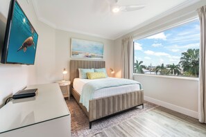 Une chambre d’hôtel moderne, équipée d’un lit, d’une table de chevet et d’un bureau.