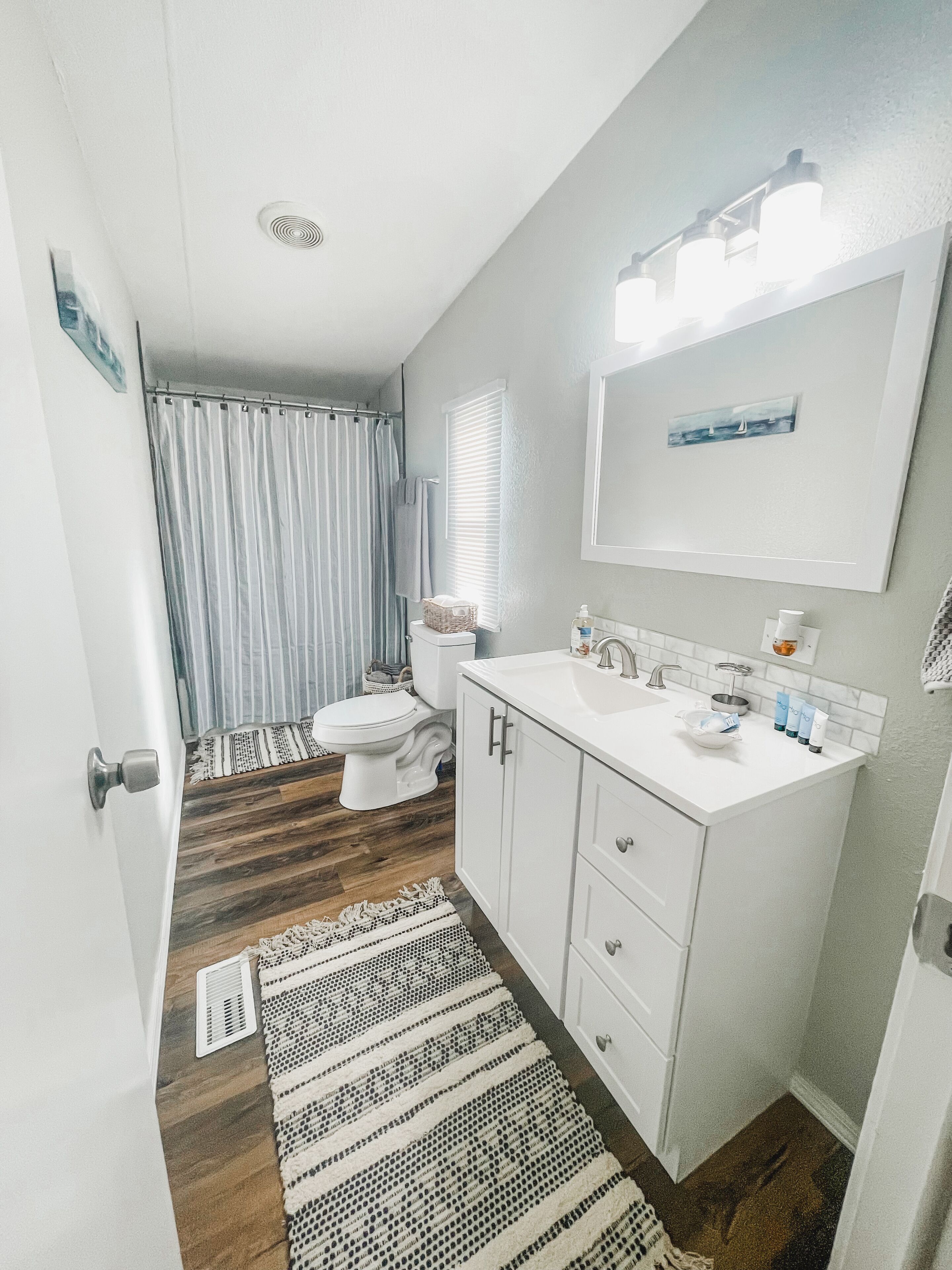 A compact bathroom with a shower, toilet, and sink.
