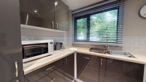 Enjoy cooking in this well-equipped kitchen with appliances, a sink, and ample countertop space.