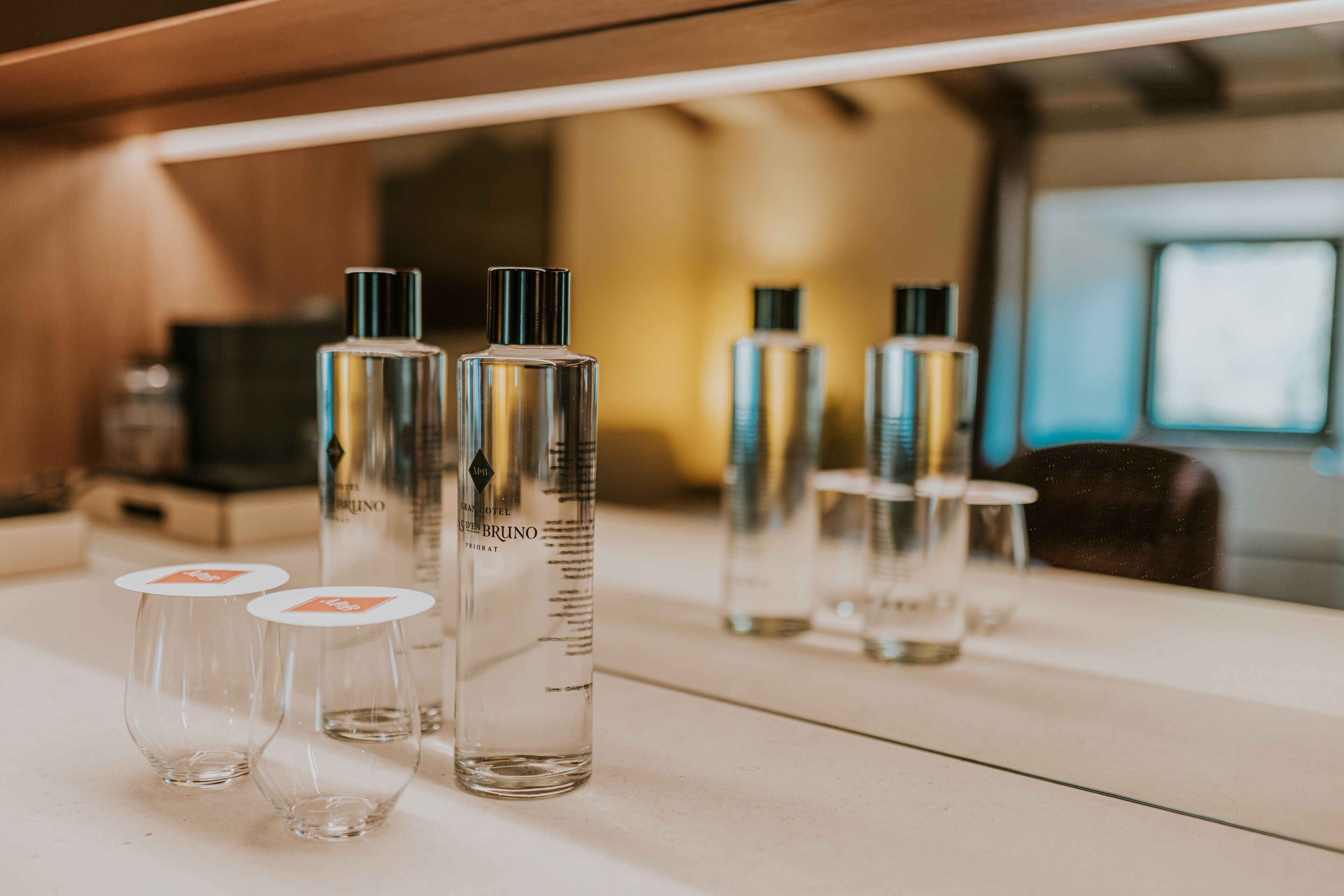 Una mesa con varias botellas y copas, probablemente en un ambiente de hotel.