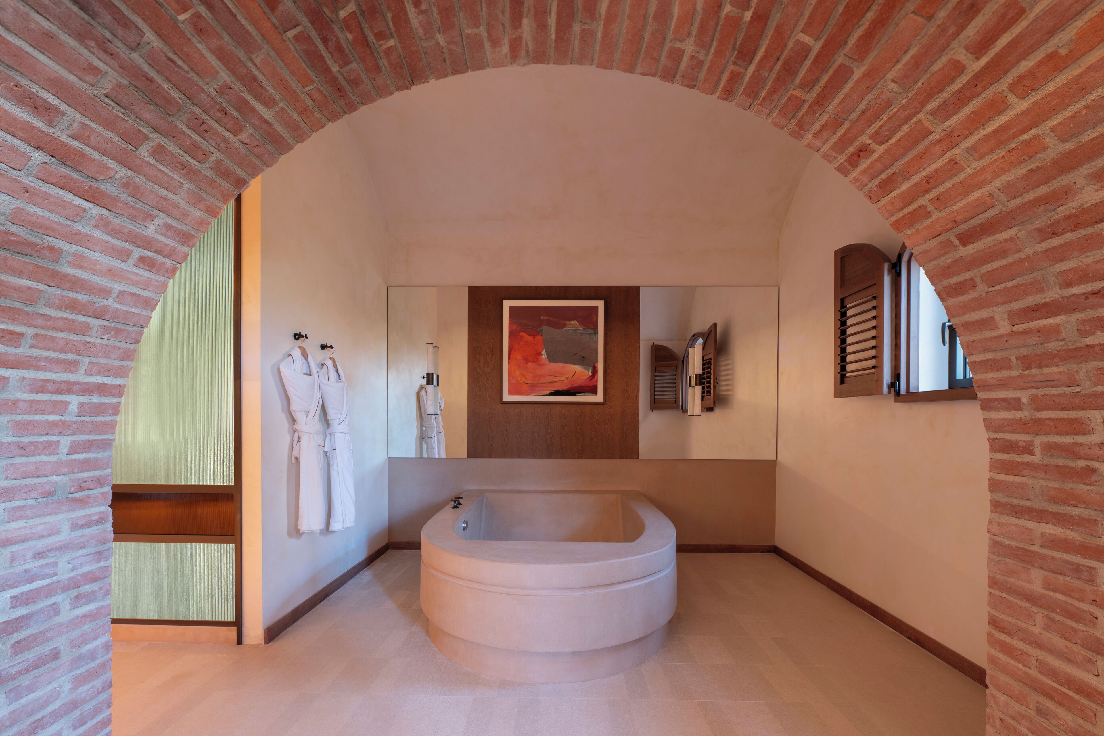 A modern bathroom with a freestanding bathtub, a wooden vanity, and a large mirror.