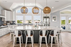 Enjoy cooking and dining in this well-equipped kitchen with a large island and bar stools.