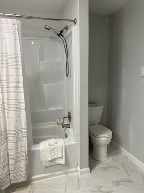 Combined shower/bathtub, hair dryer, towels, soap