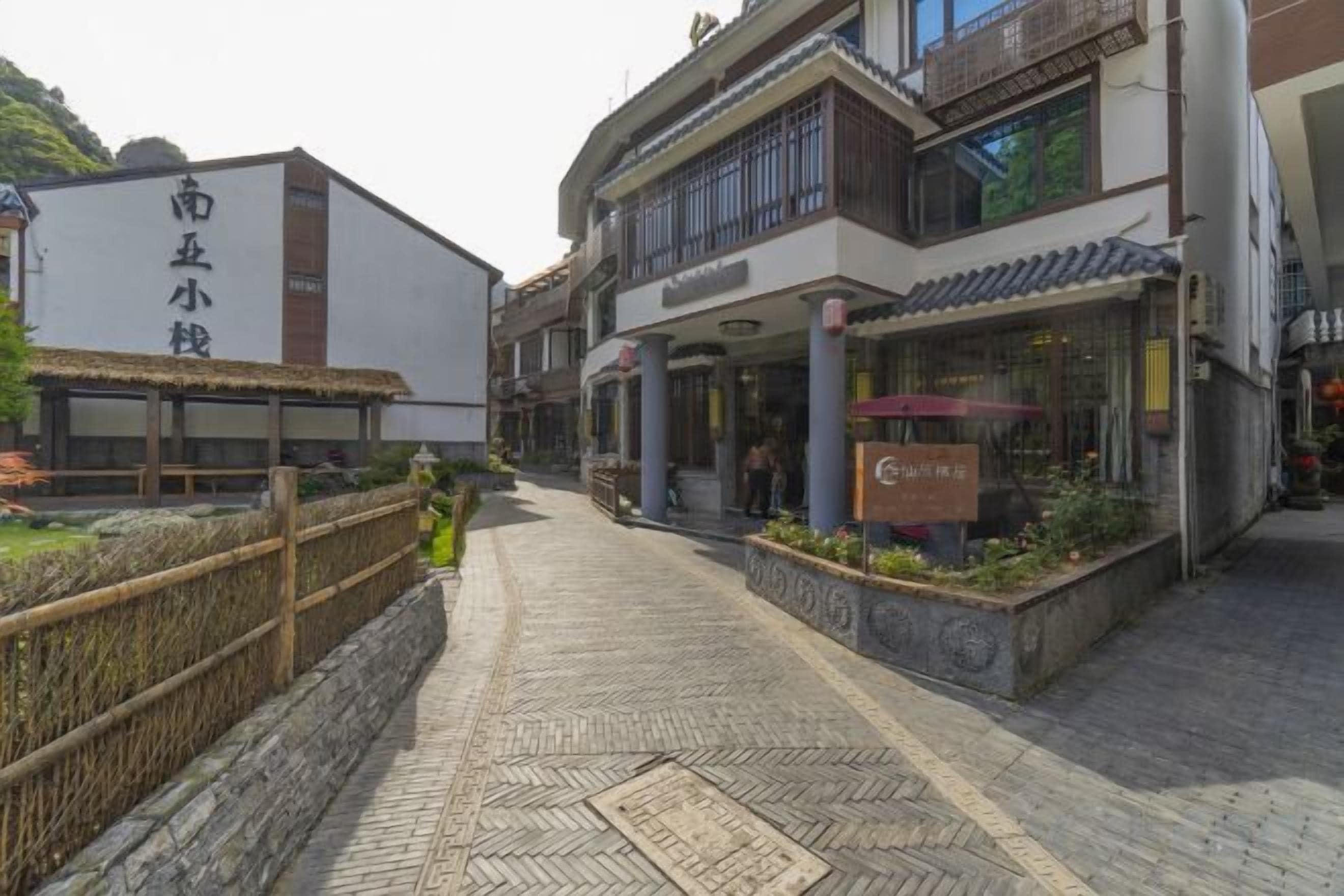 A traditional street with a restaurant and a building with a sign.