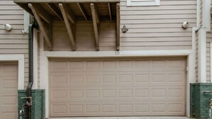 A garage door with a number "10" on it, a covered entryway, and a green brick wall. - Nashville getaway: happy hour bar, disco theme room, bunk room, sleeps 12 (Nashville)