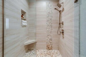 Bathtub, hair dryer, towels, shampoo