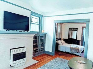 A modern room with a fireplace, a television, and a bed.
