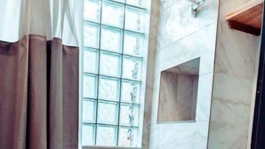Ein Badezimmer mit Badewanne, Toilette und Duschbereich.