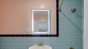 A bathroom with a sink, toilet, and bathtub.