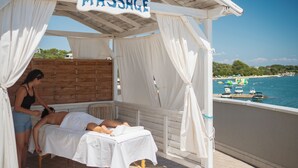 A massage area with a wooden bench and a sign that reads "MASSAGE".