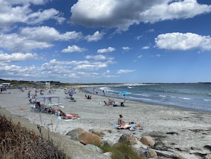A beach with people sunbathing and swimming, and a lifeguard tower in the background. - Modern Cottage near Newport - 3 bedroom/2 full baths & A/C throughout (Portsmouth)