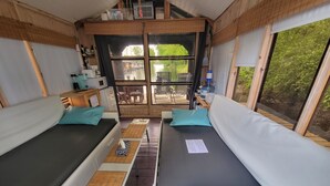 A room with two beds, a table, and a window. - Aloberge 1 (Lacolle)