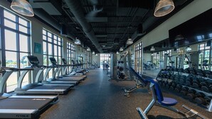 A gym with treadmills, weight machines, and dumbbells. - Beautiful home across from the Clubhouse! 5 Star Reviews! Fun Resort!  (Kissimmee)