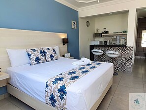 Relax in comfort with a large bed, nightstand, and convenient amenities.