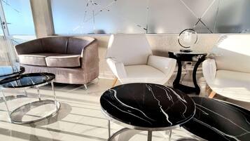 A modern living room with a sofa, chairs, and a coffee table.