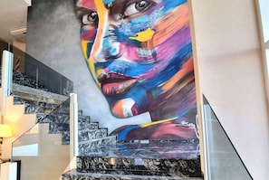 A staircase with a large mural on the wall. - Days Inn By Wyndham Dolores Hotel Termal (Dolores)