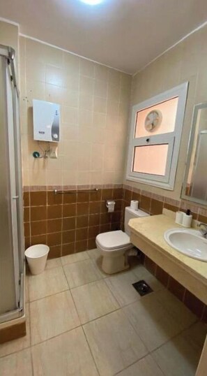 Shower, towels, soap, toilet paper