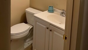 A bathroom with a toilet, sink, and mirror. - #1* 5min walk to the Beach, Amazing Virginia Pro Host. (Norfolk)