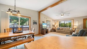 A spacious living area with a dining table, sofas, and a TV. - Cozy Lake Alice Cottage Next to Trails & WI River! Pet Friendly! (Tomahawk)
