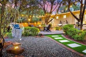 A patio area with a hanging chair, a fire pit, and outdoor seating. - Sedona Villa•Magical Backyard•Fire Pit•Hot Tub•Near Trails (Sedona)