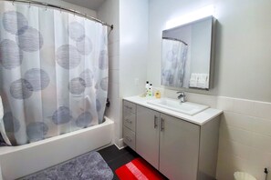 Bathtub, towels, soap, toilet paper