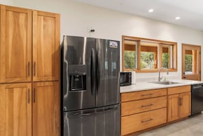 The kitchen, as well as the rest of the house at Roadrunner Canyon Ranch, is completely compliant with ADA accessibility standards. - Roadrunner | Riverfront 3BR with Views & Fire Pit (Leakey)