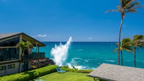 A beachfront property with a large ocean view, a pool with lounge chairs, and a visible water feature. - Remodeled Family-Size Condo with Fantastic View of the Ocean and Pool (Koloa)