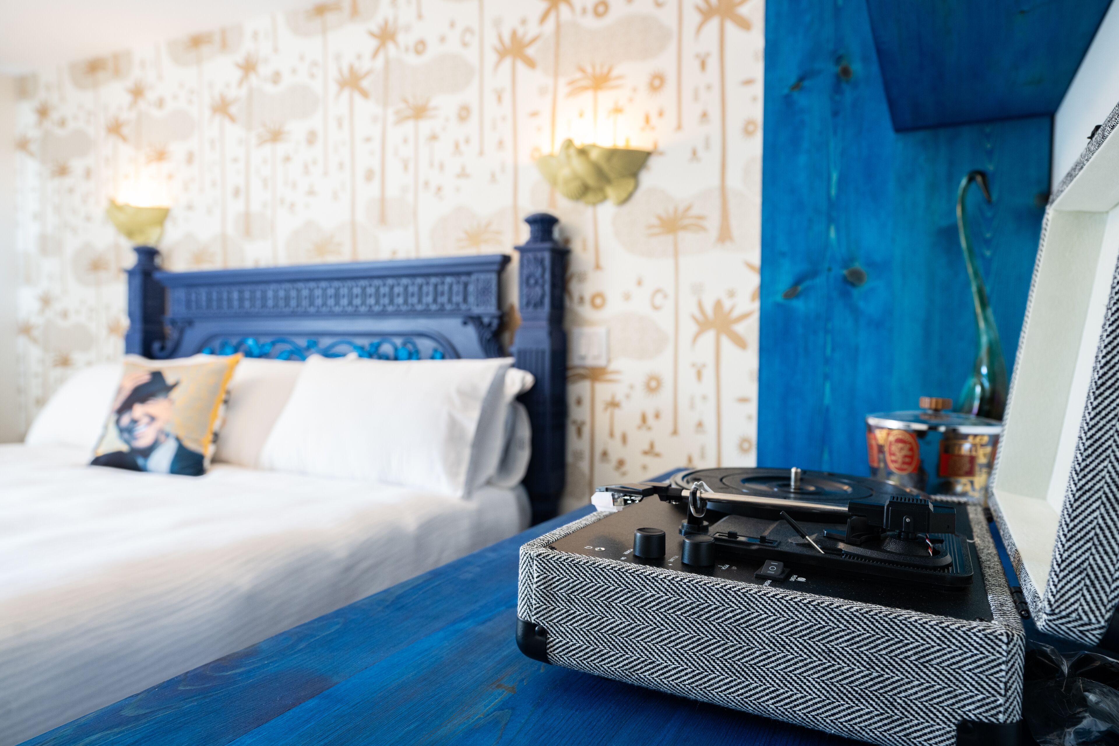 Ein Schlafzimmer mit einem Bett, einer Plattenspieler und einer Wand mit Sternenmustern.