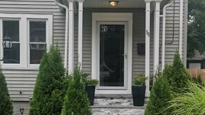 A two-story house with a front porch, a black door, and a mailbox. - Charming 3 bed/2 bath town home with gorgeous back yard (Springfield)