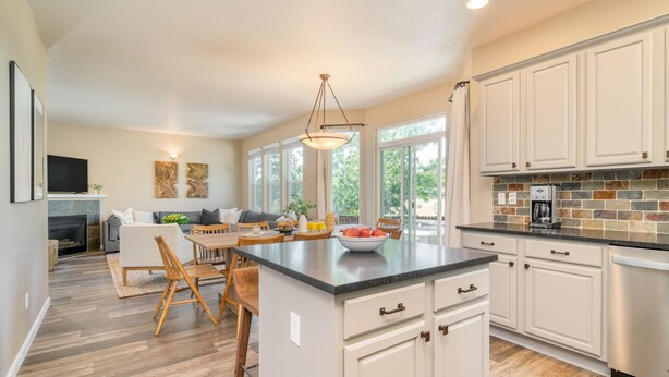 A spacious kitchen with a large island, white cabinetry, and a brick backsplash. - Hot Tub + Deck | Walk to Pickleball | Near Central Bend | Canal Trail Base Camp (Bend)