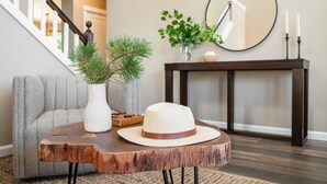 A wooden table with a hat and a vase with green plants. - Hot Tub + Deck | Walk to Pickleball | Near Central Bend | Canal Trail Base Camp (Bend)