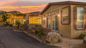 A modern building with large windows and a well-maintained garden. - Ranch House Interior - 4 bedroom, 4 bath home on-site of Galway Downs (Temecula)