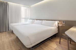 A hotel room with a large bed, a desk, and a chair. - B&B Hotel Santo Tirso (Santo Tirso)