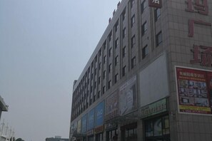 A multi-story building with commercial signage on the ground floor.