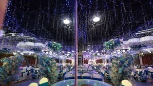 A banquet hall with round tables and chairs, decorated with blue and white linens, and surrounded by floral arrangements. - Aoliyang Business Hotel (Zhuanghe Jinma Plaza) (Zhuanghe)