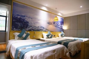 A hotel room with two beds, a large wall mural, and a hanging light fixture. - Jinbo Hotel (Yichang)