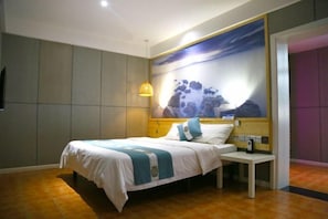 A modern bedroom with a bed, bedside table, and a large wall mural. - Jinbo Hotel (Yichang)