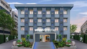 A modern hotel building with a prominent entrance, vertical light fixtures, and a well-maintained garden area. - Jinbo Hotel (Yichang)
