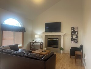Smart TV, fireplace, books, printers