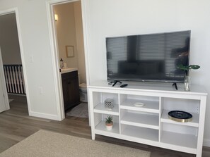 Gold Room: big smart screen tv - view of bathroom suite in gold room