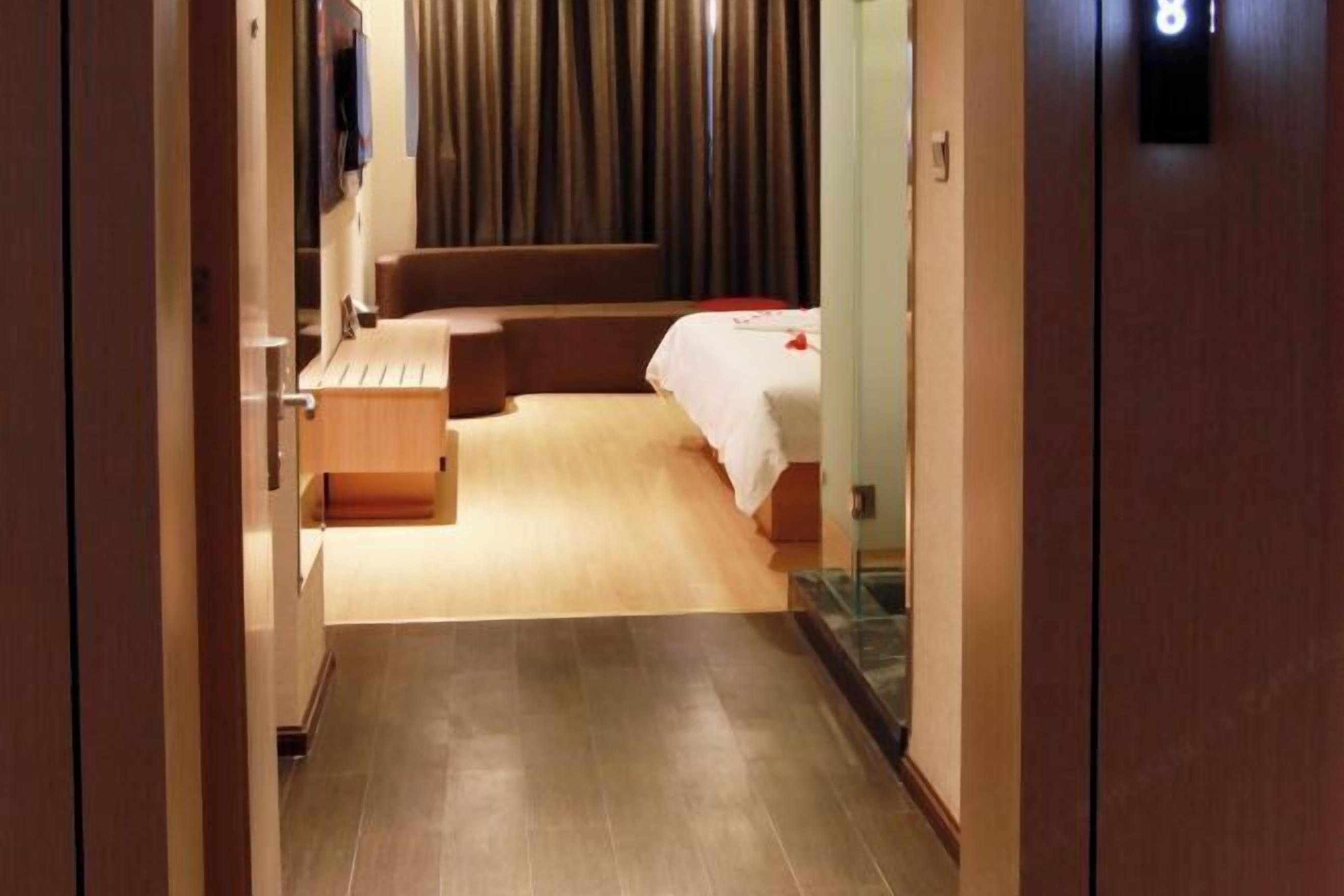 Une chambre d’hôtel comprenant un lit, un bureau, une chaise et un petit coin salon.