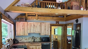 A rustic kitchen with wooden cabinets, a large island with stools, a stone backsplash, and a ceiling fan. - Hocking hills
Logan Ohio
A birds eye view cabin rentals (Logan)