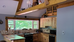 A rustic kitchen with wooden beams, a large island, and a view of greenery outside. - Hocking hills
Logan Ohio
A birds eye view cabin rentals (Logan)