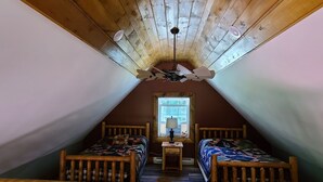 A cozy attic bedroom with two wooden beds, a ceiling fan, and a window providing natural light. - Hocking hills
Logan Ohio
A birds eye view cabin rentals (Logan)