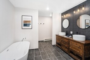 Bathtub, towels, soap, toilet paper