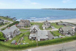 Een woongebied aan de kust met huizen, een strand en een weg.